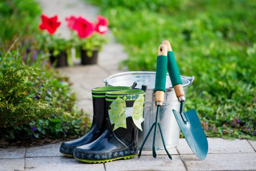 Gardener at work in a small front garden in Heston